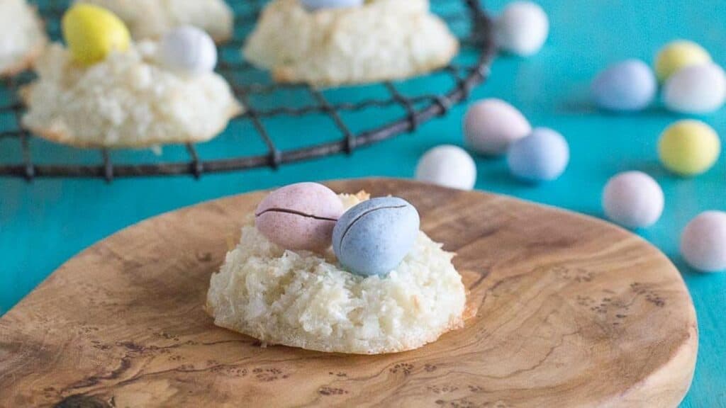 coconut-macaroon-nests-with-candy-eggs-inside-nest-on-a-wooden-board.
