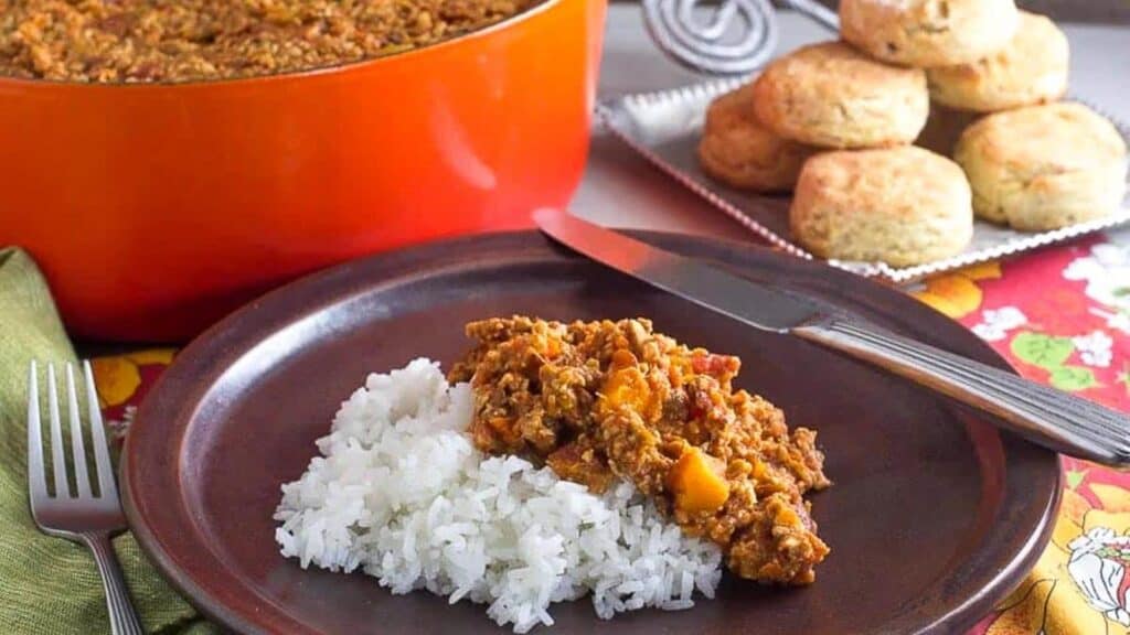 vegan-tempeh-chili-with-butternut-squash-on-brown-plate-with-rice.