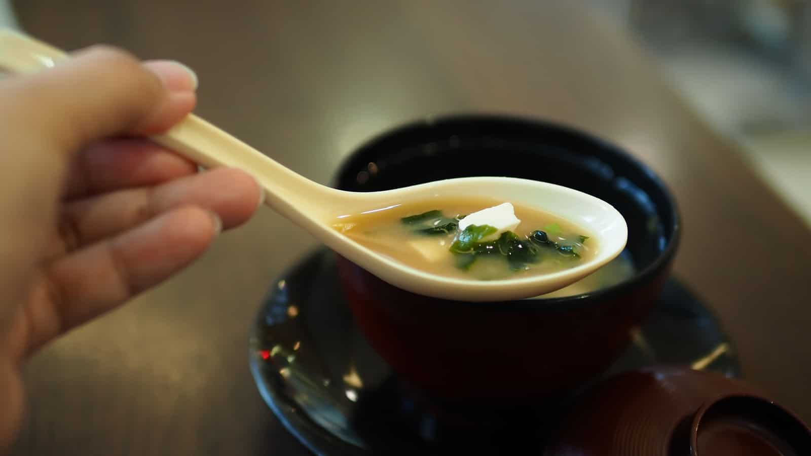 miso soup in bowl and on spoon.