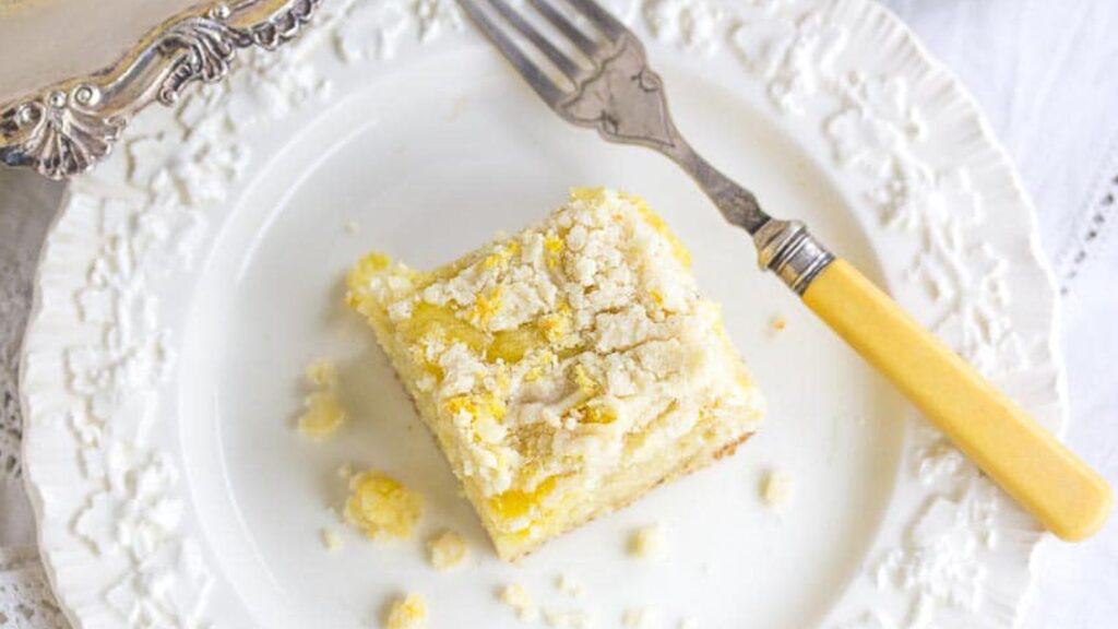 one-square-of-Low-FODMAP-Lemon-Crumb-Cake-on-a-white-plate-with-antique-fork-1.