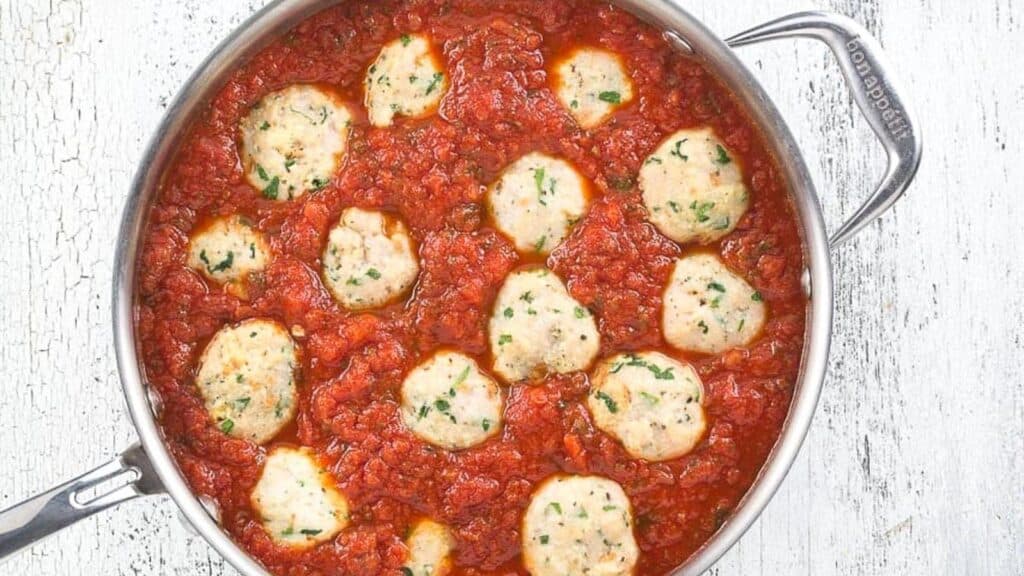 turkey-meatballs-in-tomato-sauce-in-a-saucepan-on-a-white-background.