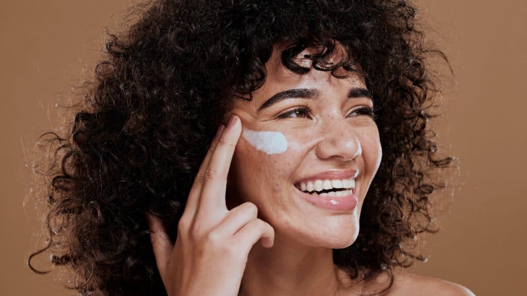 woman applying face cream.