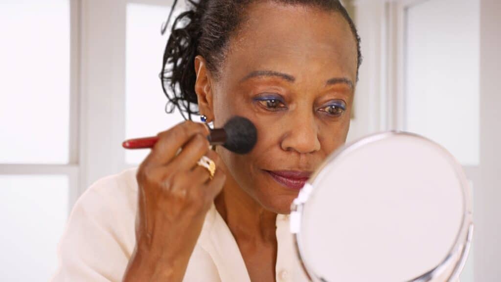 woman applying makeup. 