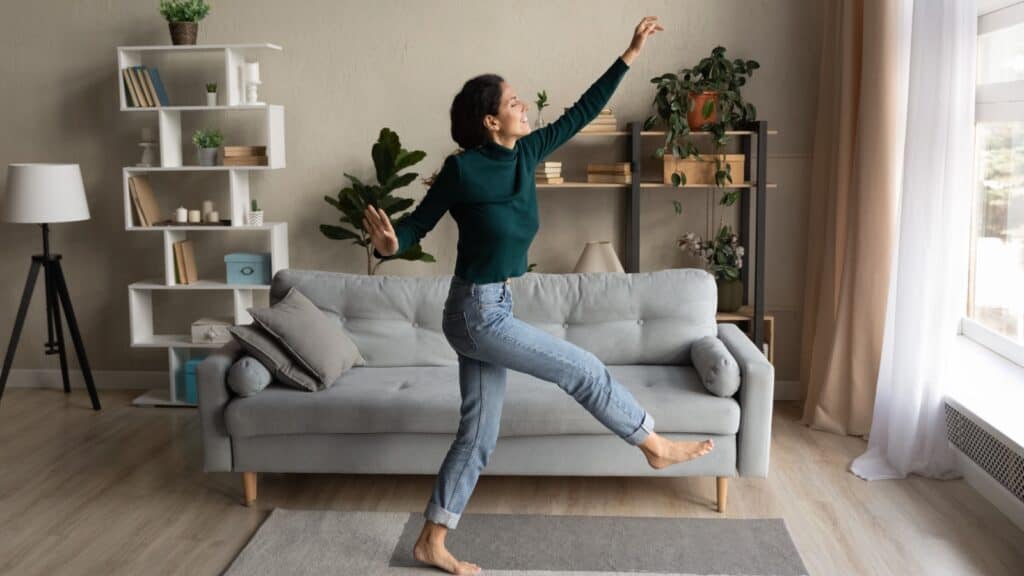 woman dancing in home barefoot.