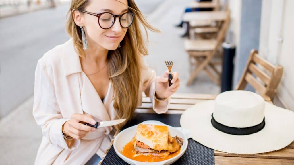 woman eating in Portugal.