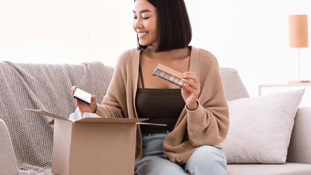 woman opening box of makeup.