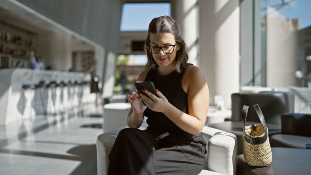 woman texting while at hotel. 