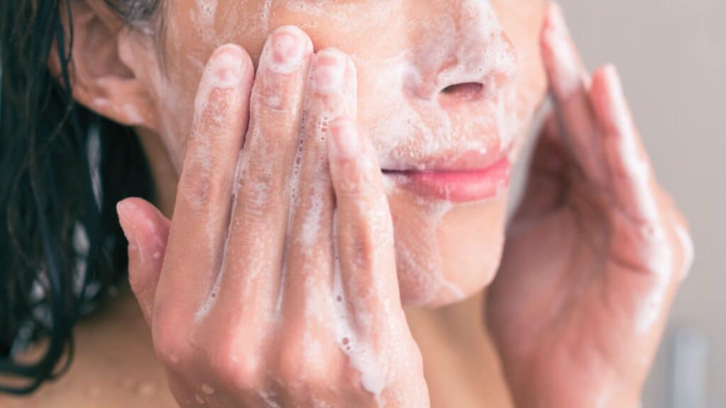 woman washing face.