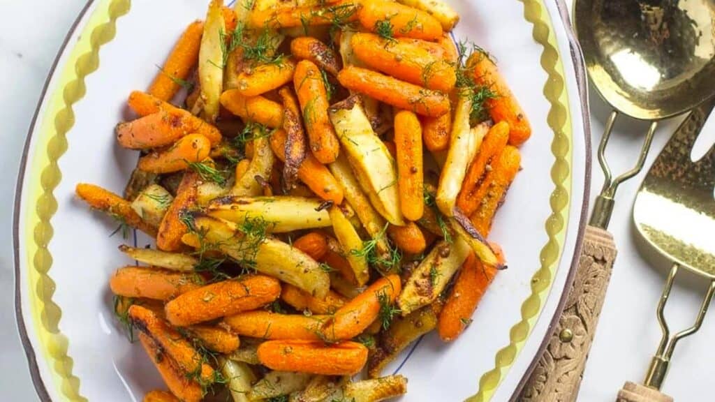 Carrots-Parsnips-with-Dijon-butter-on-oval-platter-with-serving-spoon-and-fork.