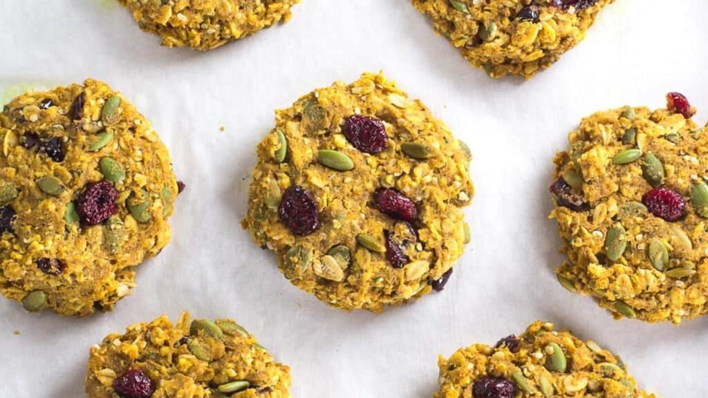 Pumpkin-Cranberry-Oat-Breakfast-Cookies-on-pan-lined-with-parchment-paper.