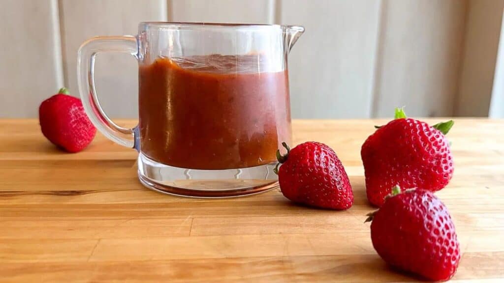 Strawberry-Chipotle-BBQ-Sauce-in-pitcher-with-berries-alongside.