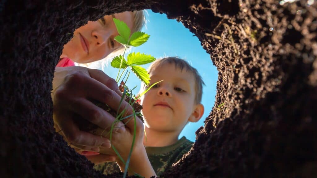 Mom and child planting.