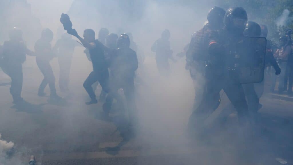Protesters surrounded by tear gas,
