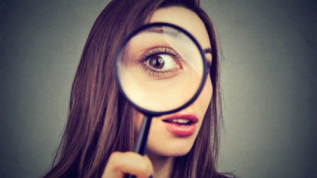 curious woman with magnifying glass. 