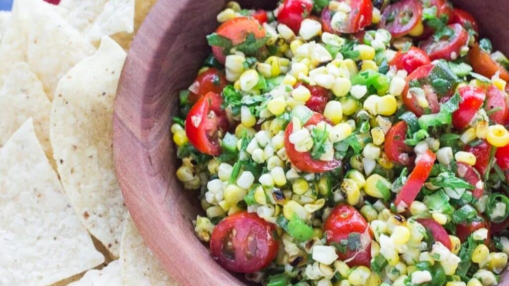 grilled-corn-salasa-in-wooden-bowl-with-side-of-corn-chips.