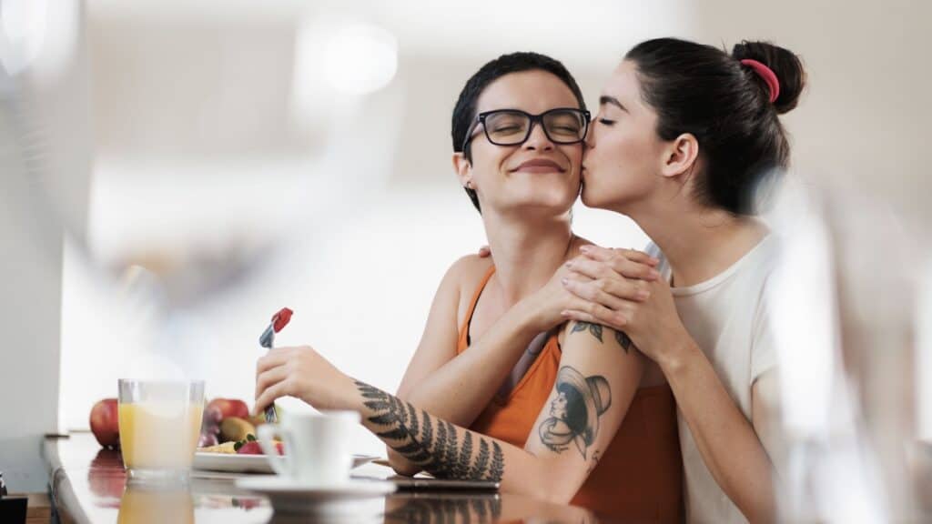 two women kissing. 