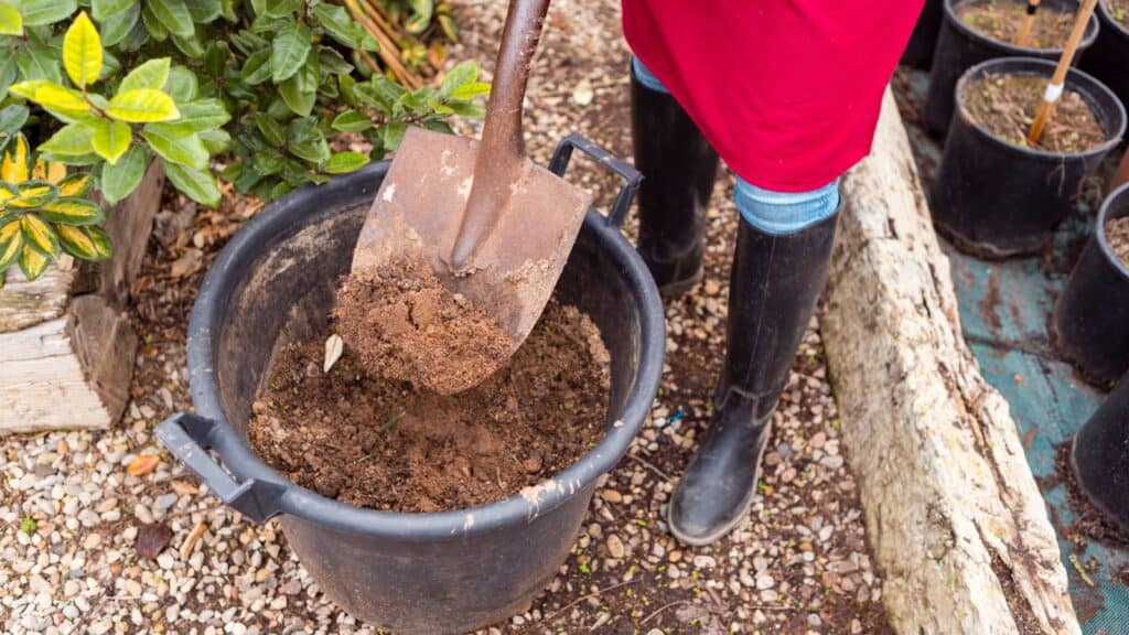 woman in boots gardening. 