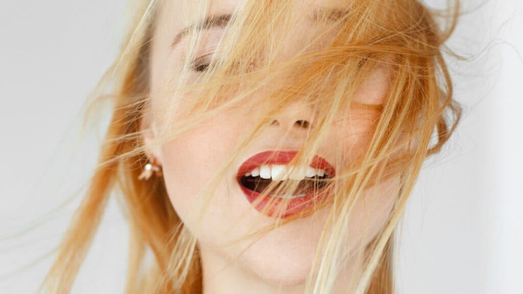 woman smiling. red lipstick. 