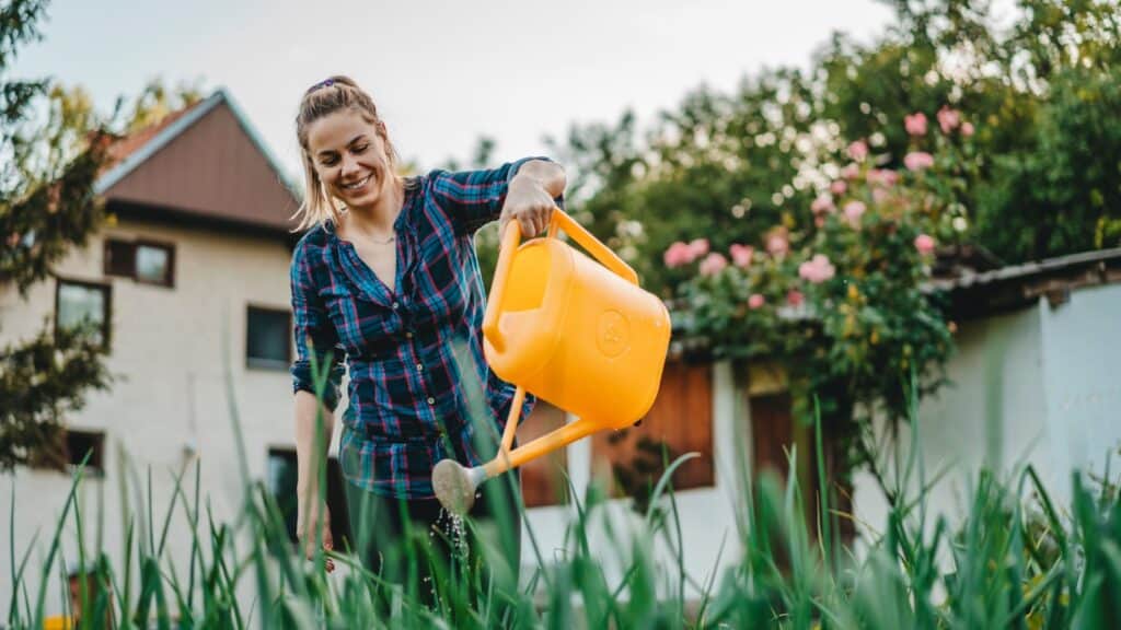 woman watering garden. 