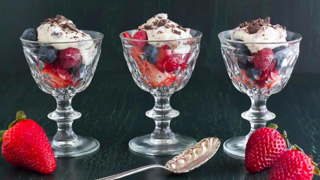 3-glass-goblets-holding-cannoli-cream-on-mixed-berries.