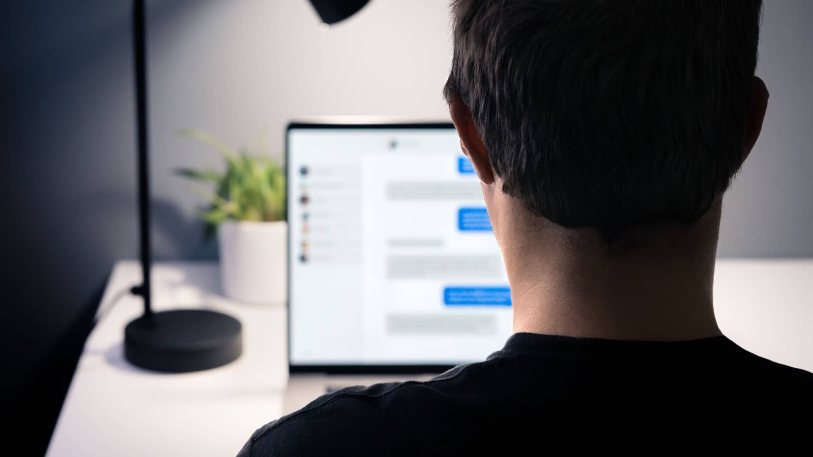 Man texting on computer.