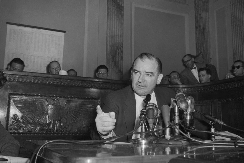 Senator Joe McCarthy at the hearing table. 