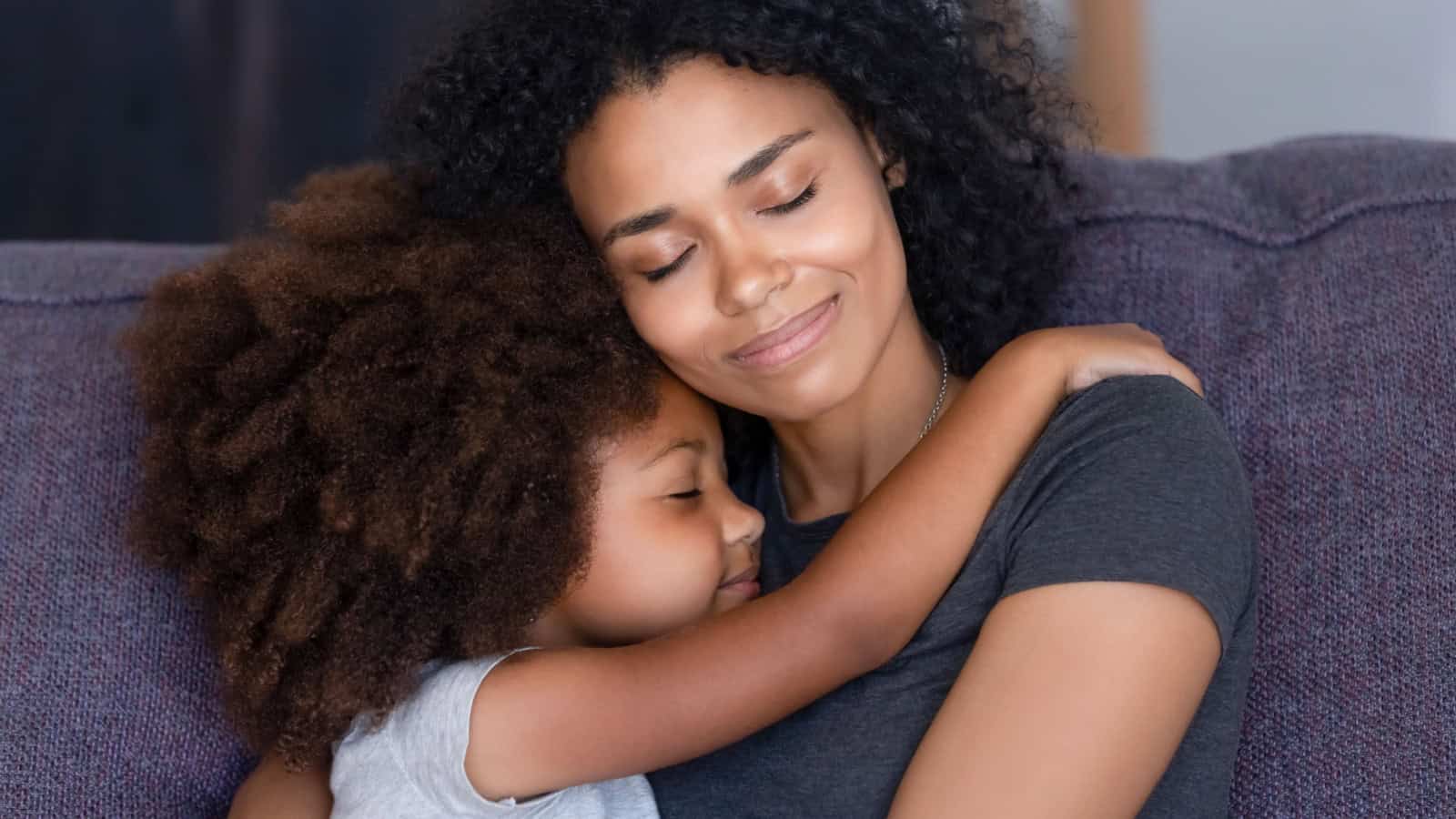 Mom and child hugging.