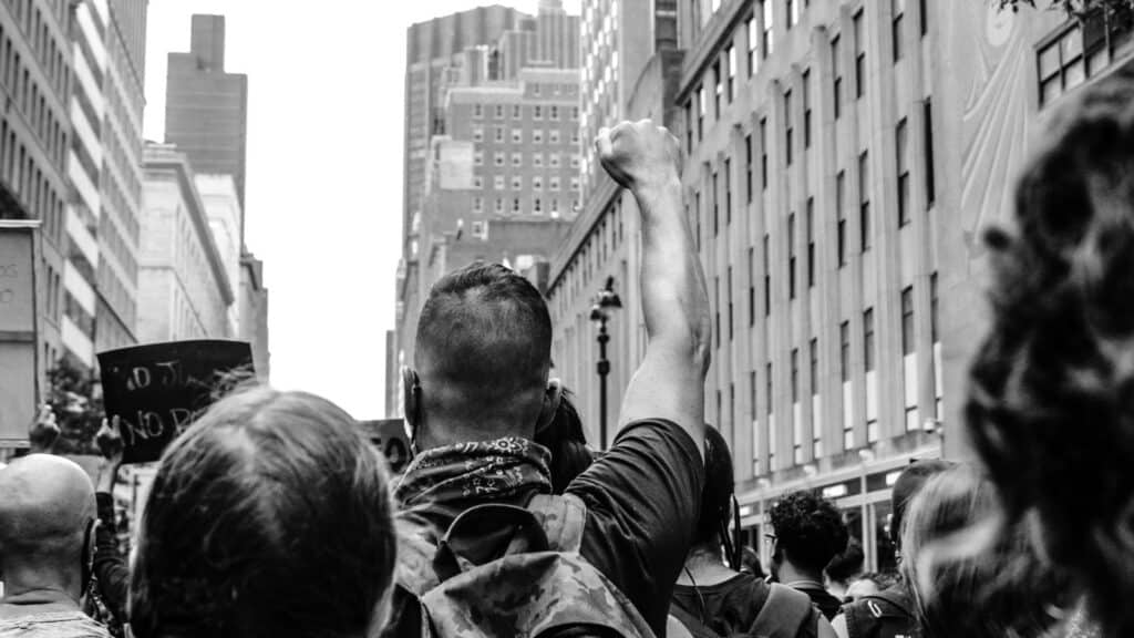 rear view of protester holding his arm in the air