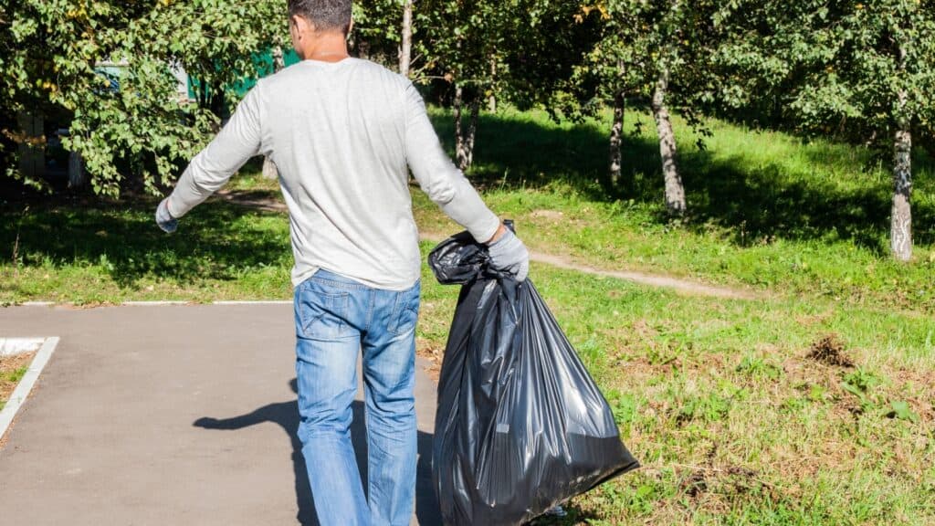 Schlep. carrying garbage.