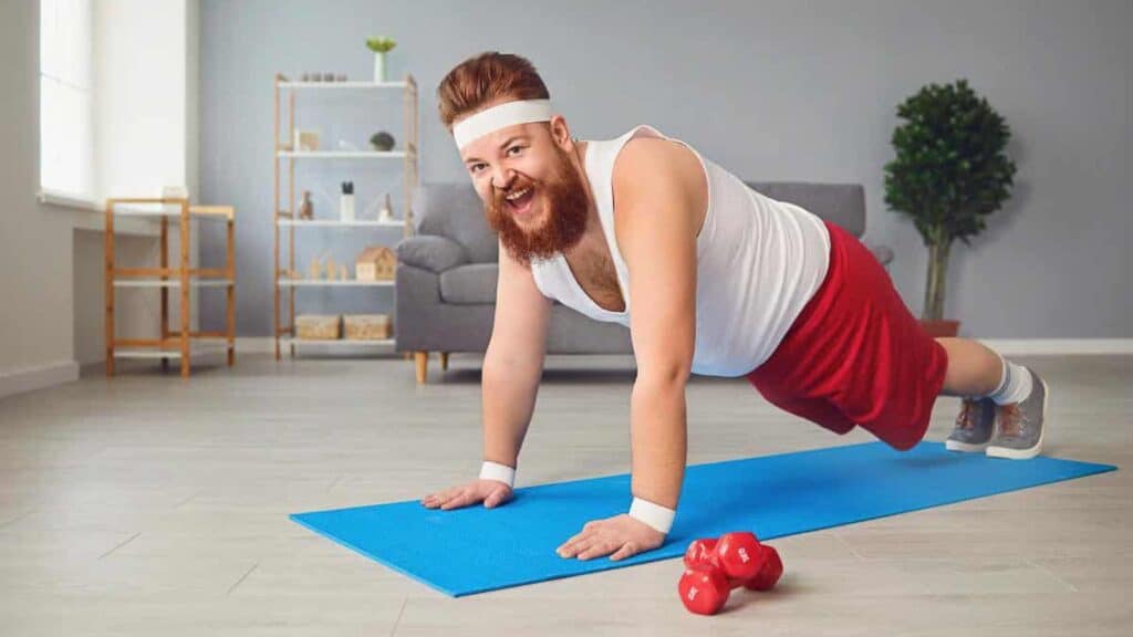 man-in-red-shorts-holding-a-plank.