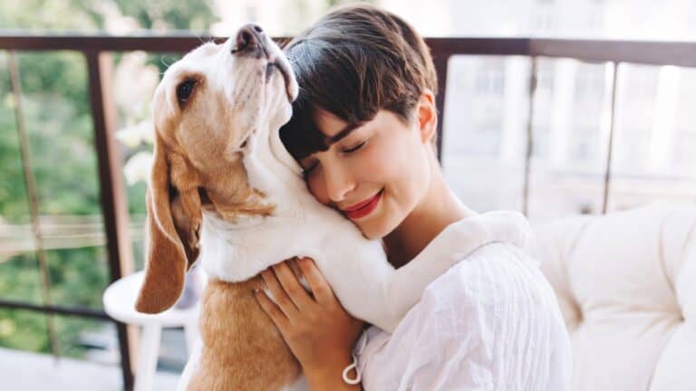 woman hugging dog.