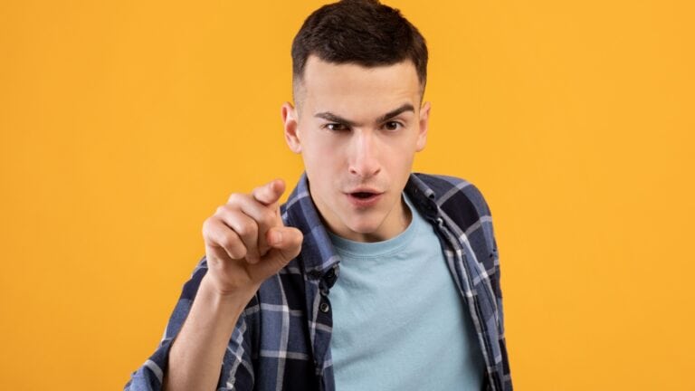 Judgmental angry young man. Finger pointing.