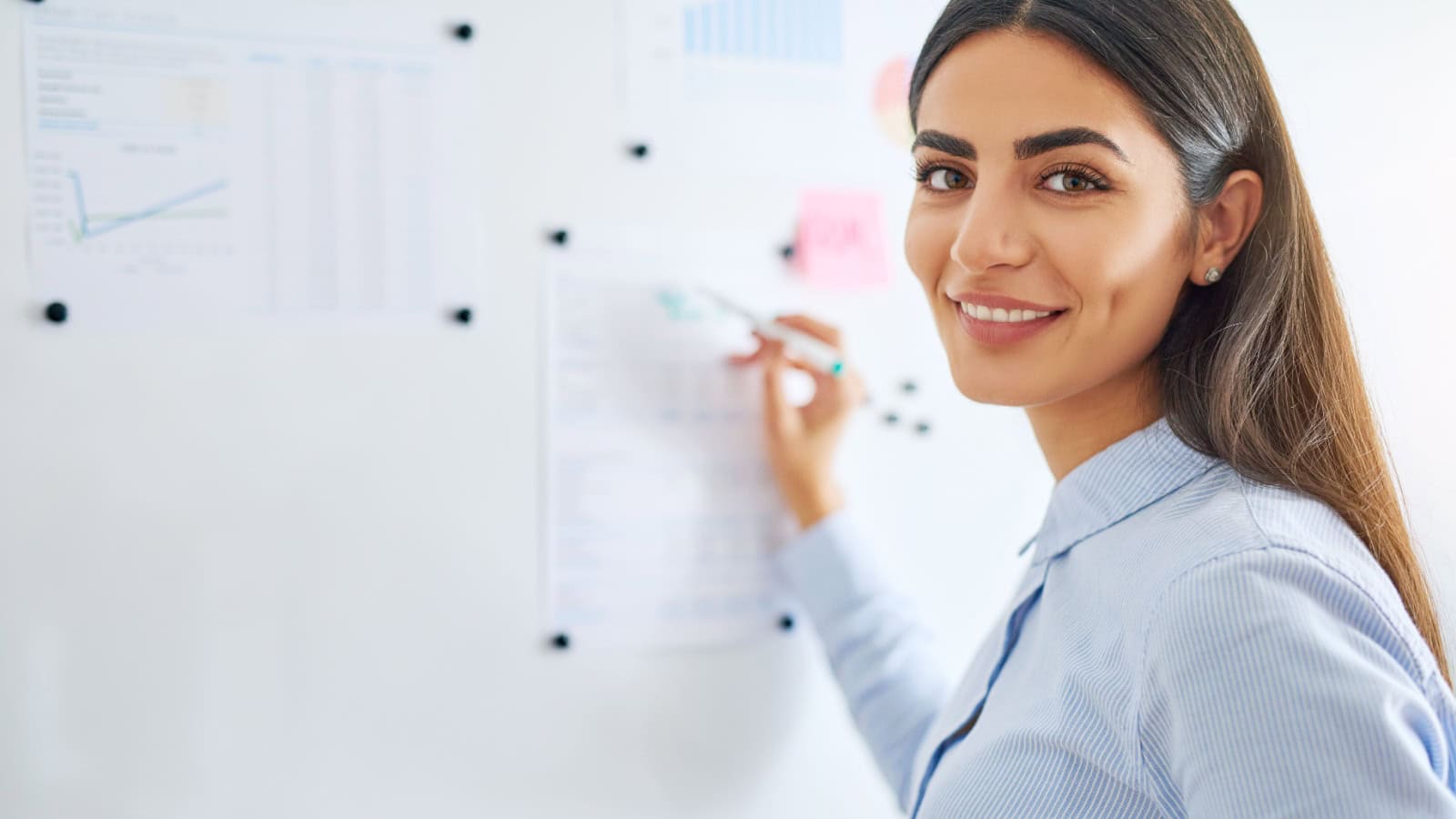Teacher. Woman writing on board.