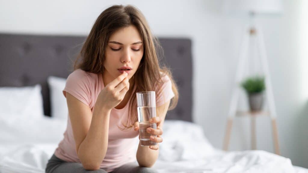 woman taking pill.