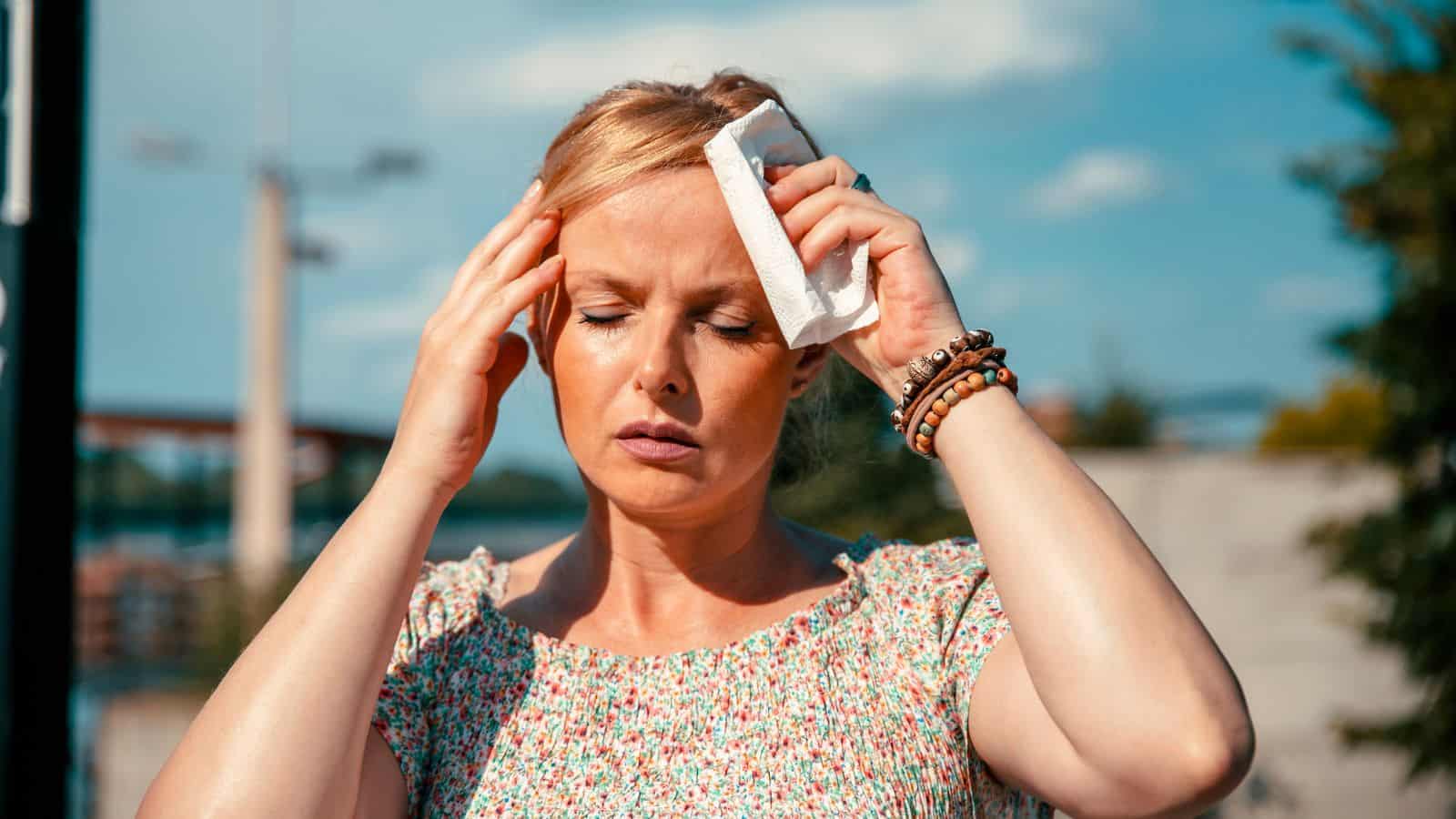 woman sweating in heat and hot sun.