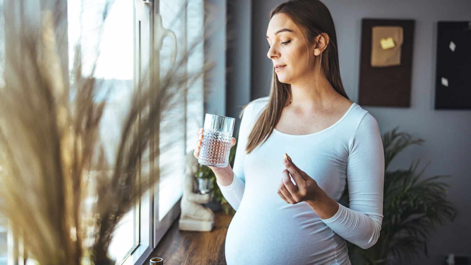 Pregnant woman taking vitamins.