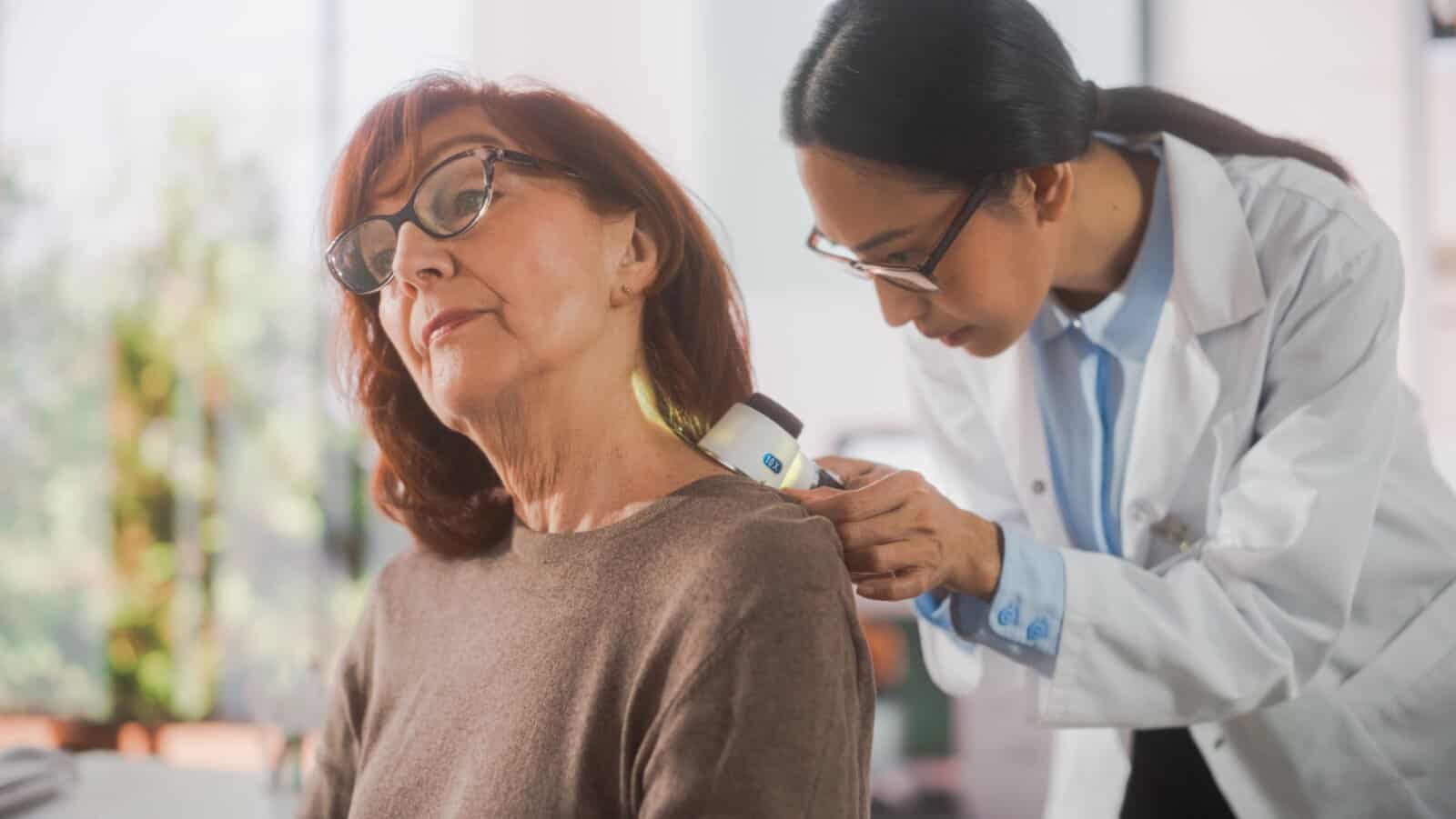 Doctor checking for melanoma.