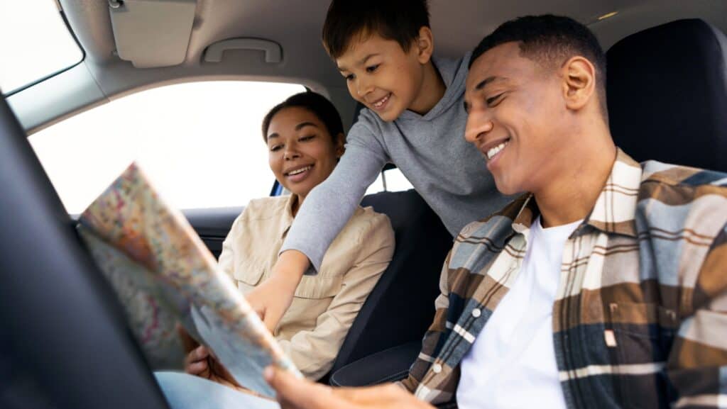 family in car on trip.