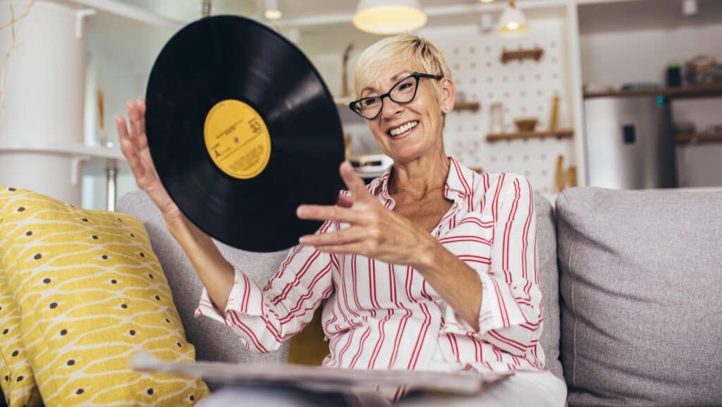 senior woman with vinyl record.