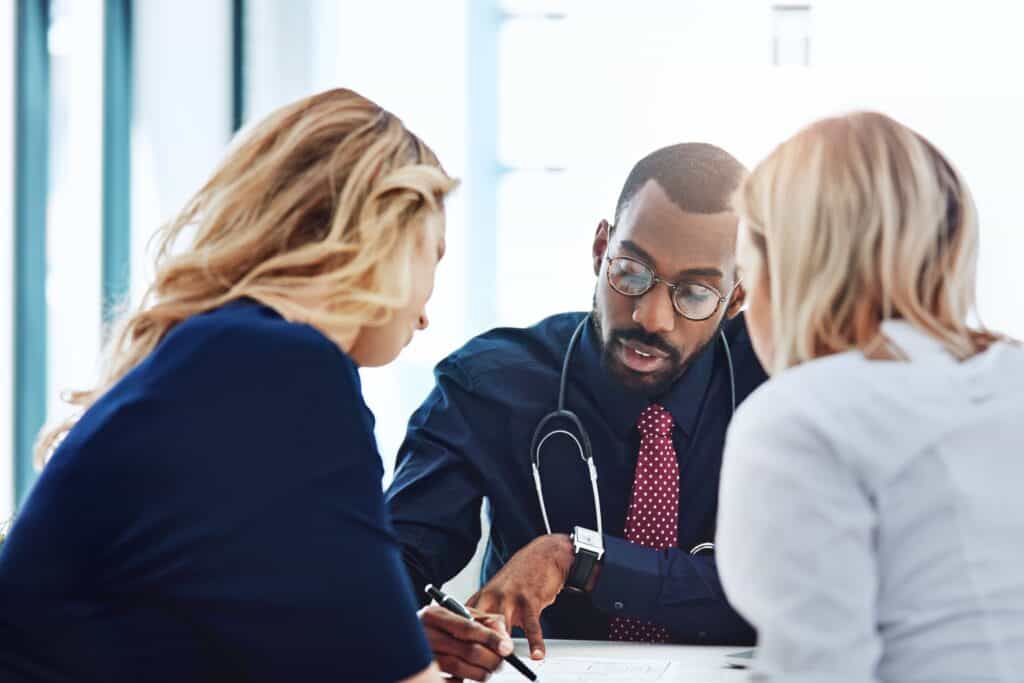 two people meeting with doctor.