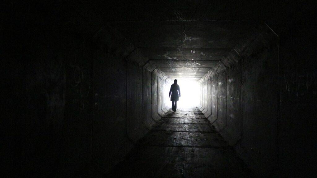 Walking through tunnel.