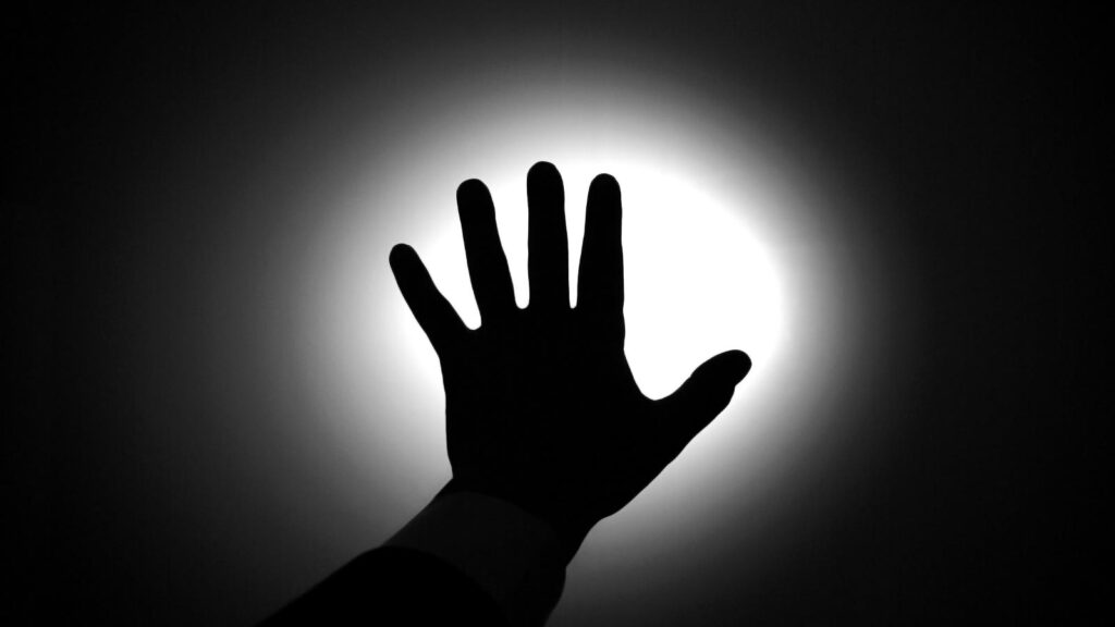 Hand reaching for light.