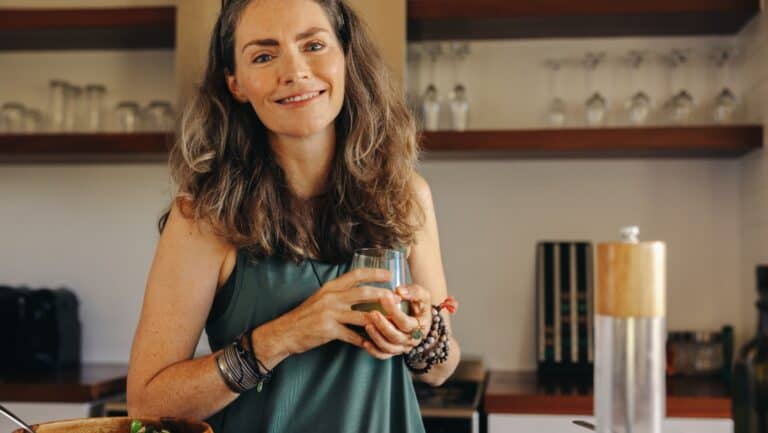 woman in kitchen cooking. Happy.