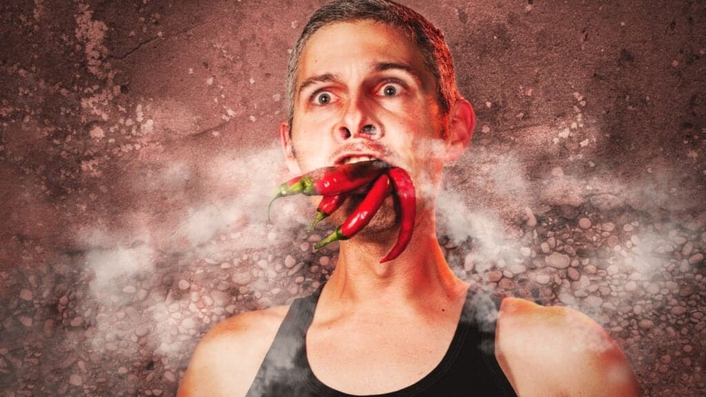 Man eating hot peppers. 