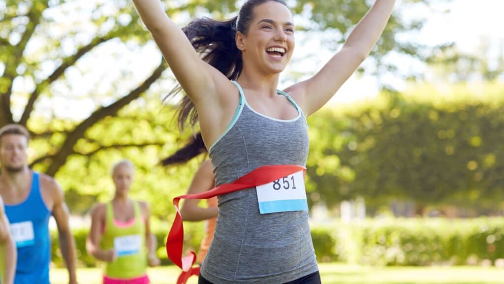 happy woman winning marathon.