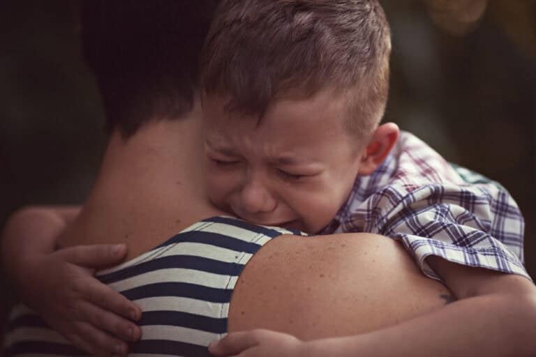 Child crying on parent