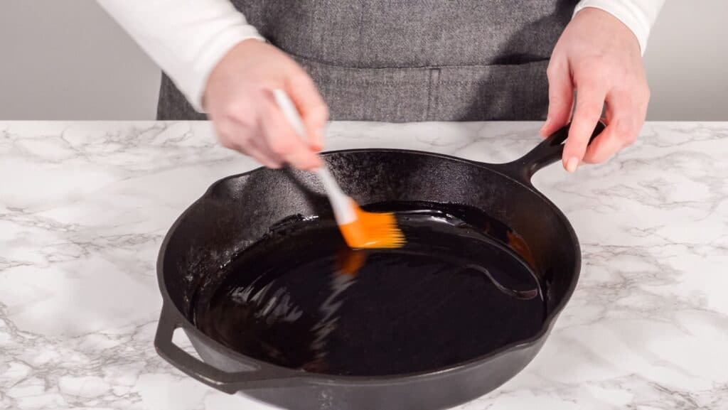 Applying oil to cast iron pan.