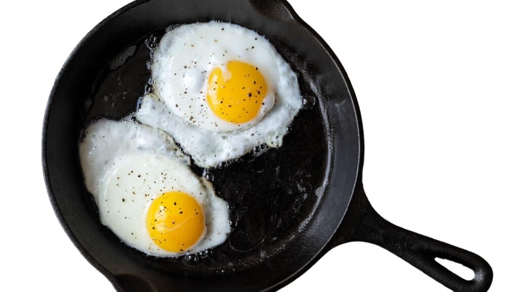 Fried eggs in cast iron pan.