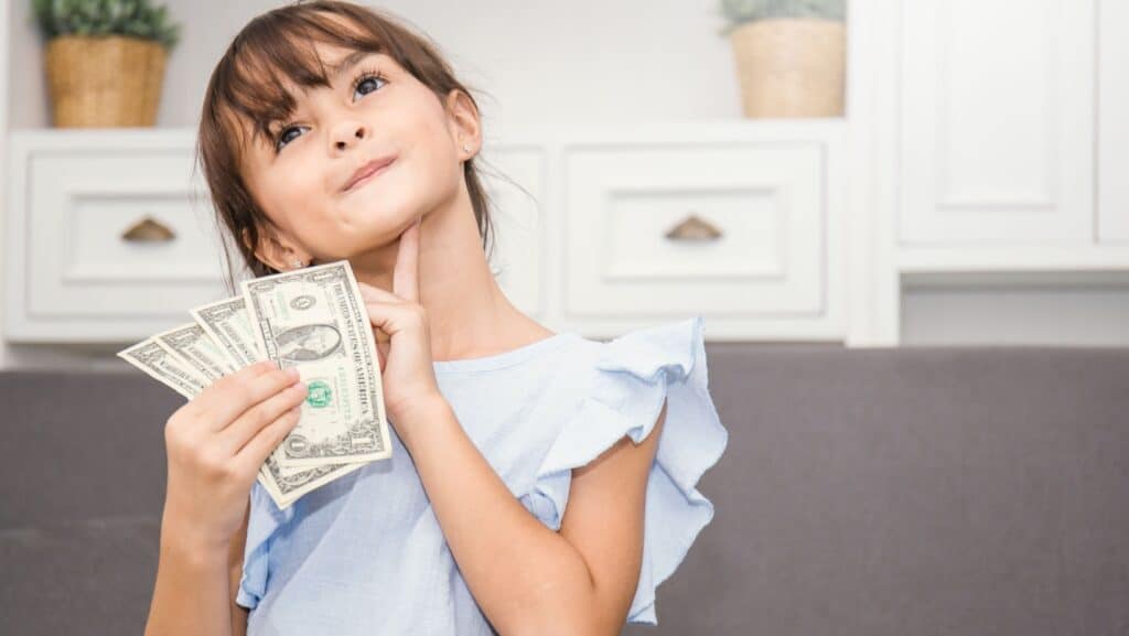 little girl thinking about spending allowance.