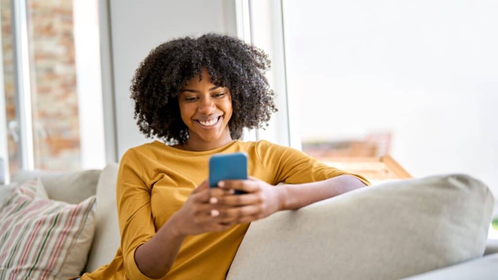 woman on smartphone. smiling.